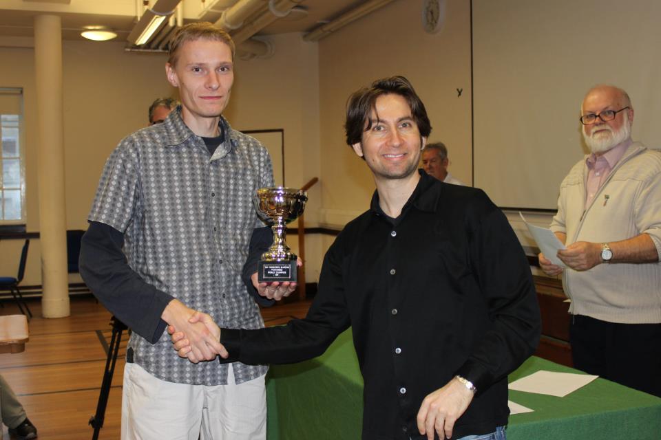 Andres Kuusk left being recieving the Pentamind Trophy from Etan Ilfeld